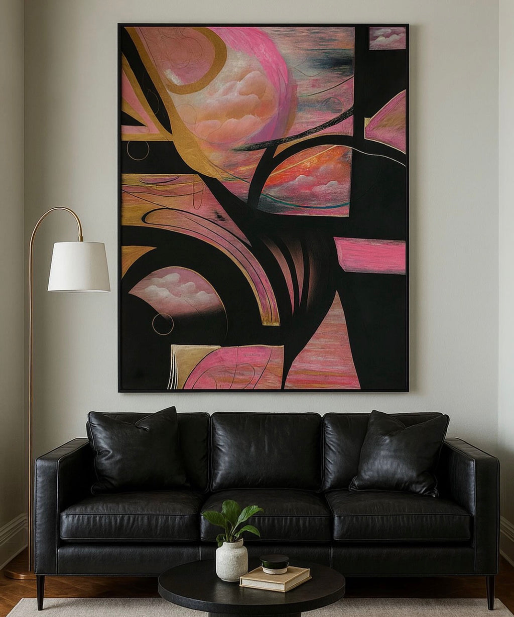 A large abstract canvas painting with pink, peach, black, and gold brushstrokes hangs on a light gray wall above a black leather sofa in a modern living room setting.